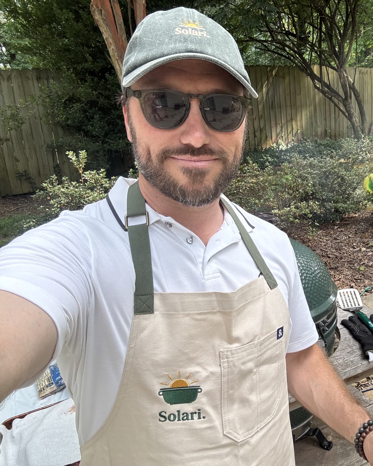 Jeremy grilling in a Solari apron and hat